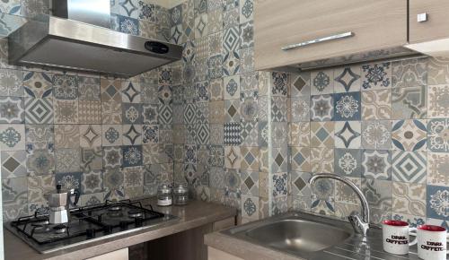 a kitchen with a sink and a stove at Casa Vacanze Zia Concetta in Nardò