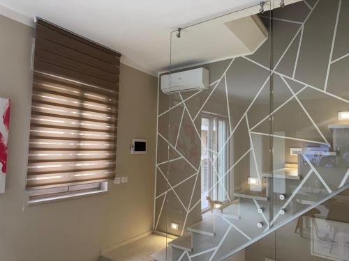 a staircase in a room with a glass wall at La piccola Balilla in Venosa