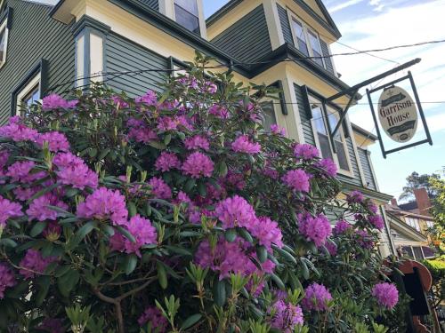 a house with purple flowers in front of it at Garrison House Inn in Annapolis Royal