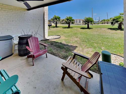 two chairs and a picnic table on a patio at Sandy Shores in Port Aransas