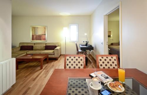 a living room with a couch and a table at Grand Brizo Comahue in Neuquén