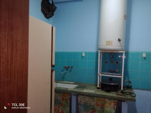 a bathroom with a sink and a blue tile wall at Quinta Atalaya in General Rodríguez