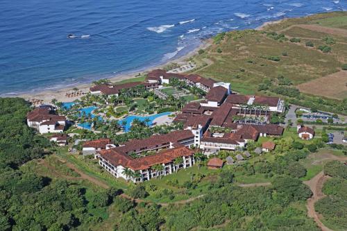 an aerial view of a resort next to the ocean at JW Marriott Guanacaste Beach Resort in Tamarindo