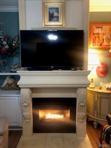a fireplace with a tv on top of it at The Cozy Coast Nest in Oceano