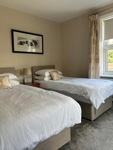 a bedroom with two beds and a window at Caistor Bed & Breakfast in Caistor