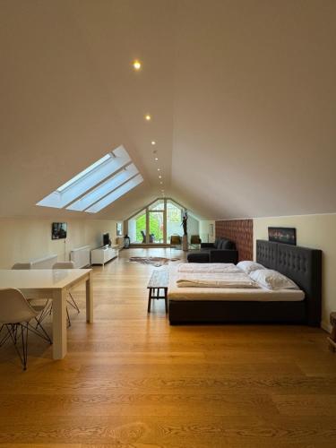 a bedroom with a bed and a desk in a room at Six! Eat Work Sleep in Brühl