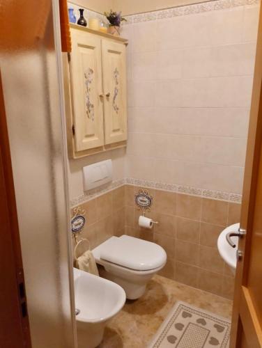 a small bathroom with a toilet and a sink at Appartamento bambi abetone in Abetone