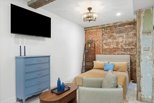 a bedroom with a bed and a tv on a wall at Park Hotel Studio Suite 203 in Chattanooga
