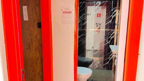 a red bathroom with a toilet and a sink at COACHHOSTEL7 in São Paulo