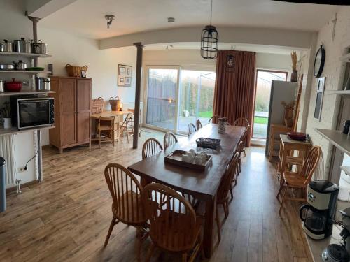 a kitchen and dining room with a table and chairs at Farmhouse home in Eede in Eede