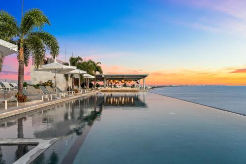a swimming pool with a view of the ocean at Panarea Beachfront Living - Pools Spa Gym & Luxury Amenities in Bucerías