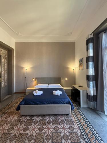 a bedroom with a bed with two towels on it at GUEST HOUSE BOSCO in Palermo