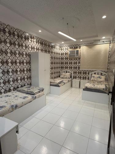 a room with three beds on display in it at النبلا الذهبي in Medina