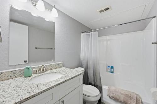 a bathroom with a sink and a toilet and a mirror at 2-bedroom with large living area in Denton