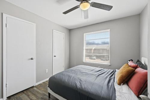 a bedroom with a bed and a ceiling fan at 2-bedroom with large living area in Denton