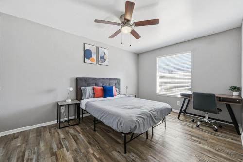 a bedroom with a bed and a ceiling fan at Denton pad with 2BR comfort in Denton