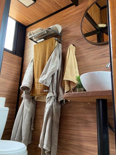 a bathroom with a sink and towels on a wall at Mini Cabana in Serra do Cipo