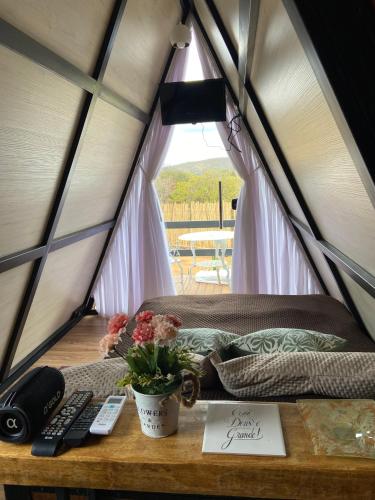 a room with a bed and a table in a tent at Mini Cabana in Serra do Cipo