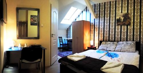 a bedroom with a bed and a desk and a mirror at Garden House in Budapest