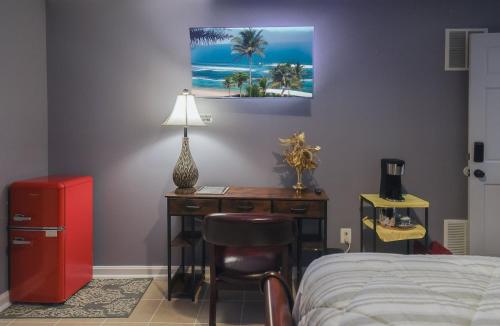 a bedroom with a desk and a bed with a lamp at Stylish Studio Escape - Calm & Convenient Lanham in Lanham