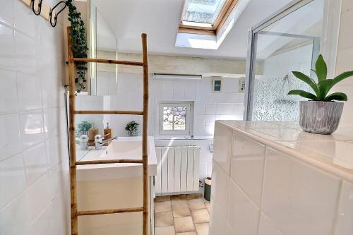 a bathroom with a ladder next to a sink at La Rochere in Sampzon