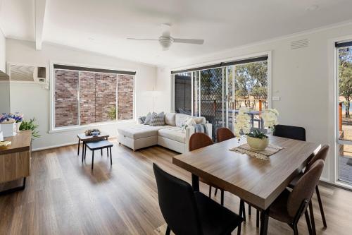 a living room with a table and a couch at Nanda Lake House in Bonnie Doon