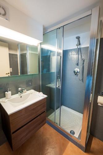 a bathroom with a sink and a shower at B&B Arcolobello ApartHotel in Corato