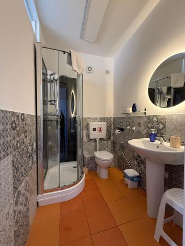 a bathroom with a shower and a toilet and a sink at GUEST HOUSE BOSCO in Palermo
