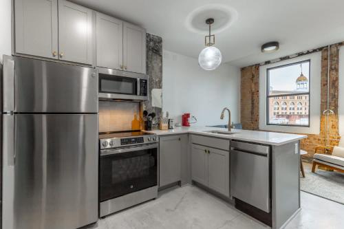 a kitchen with a stainless steel refrigerator and a sink at Park Hotel 1BR Suite 402 in Chattanooga