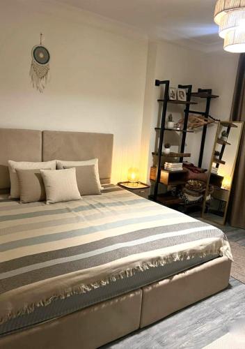 a bedroom with a large bed with white pillows at Sun capital stylish apartment in ‘Ezbet `Abd el-Ḥamîd