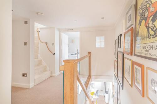a staircase in a home with art on the wall at Washmere House in Colerne