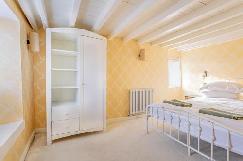 a bedroom with a bed and a white closet at Washmere House in Colerne