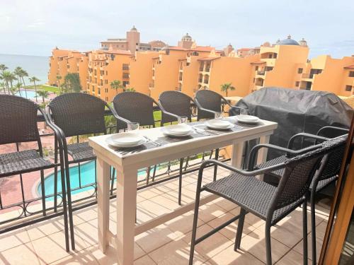 a table and chairs on the balcony of a building at Princesa 3BR 2BA OV Penthouse- 502D in Campo del Medio