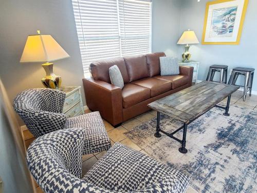 a living room with a couch and a table and chairs at Beautiful Views And Just Steps To The Beach - #38 Sleeps 7 in Gulf Shores