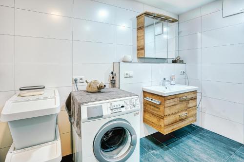 a laundry room with a washing machine and a sink at FeWo Bad Mergentheim in Bad Mergentheim