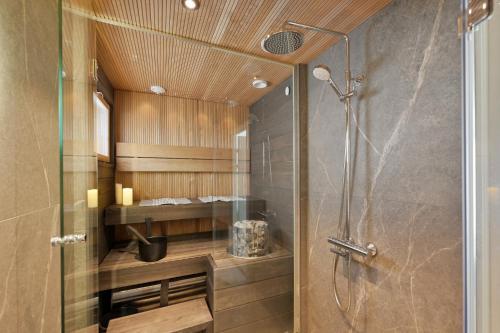 a bathroom with a shower with a glass door at Levi Skyview Igloo in Levi