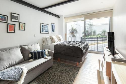 a living room with a couch and a tv at Uppermost 3BR, Gym, Roofgarden. Socrates in Mexico City