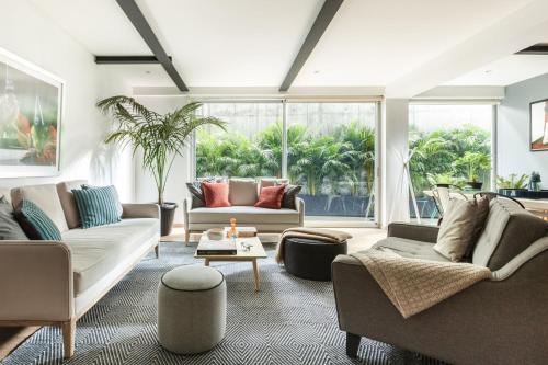 a living room with two couches and a table at Uppermost 3BR, Gym, Roofgarden. Socrates in Mexico City