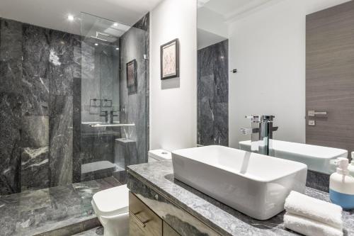 a bathroom with a white sink and a toilet at Uppermost 3BR, Gym, Roofgarden. Socrates in Mexico City