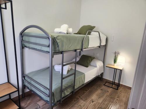 a couple of bunk beds in a room at Pinedo Playa Holiday in Valencia