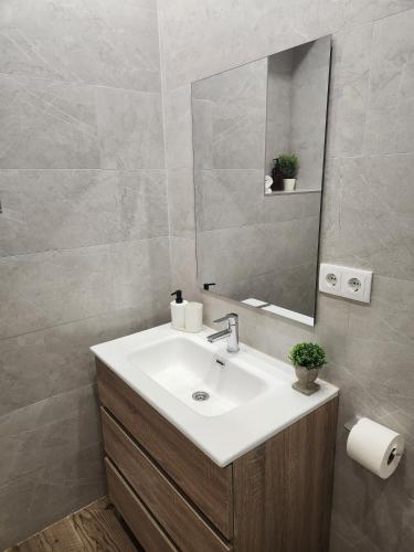 a bathroom with a sink and a mirror at Pinedo Playa Holiday in Valencia