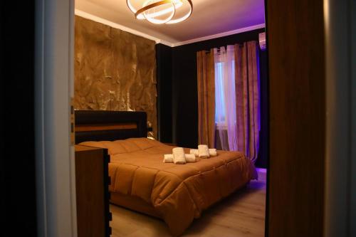a bedroom with a bed with three candles on it at Amiri Lux Suites in Shkodër