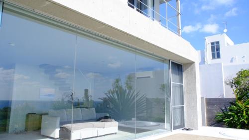 a large glass window on the side of a house at CHLOROBIANCO amami in Amami