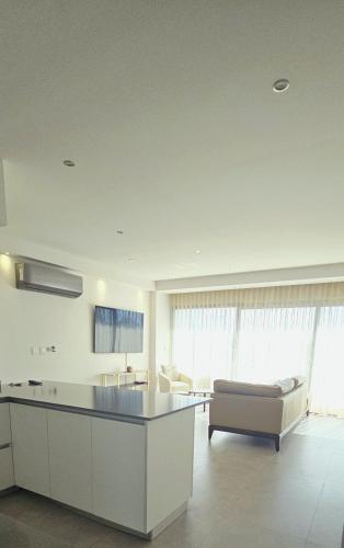 a kitchen and living room with a couch and a table at Luxury Condo Residencial Area Close to Everything in Puerto Vallarta