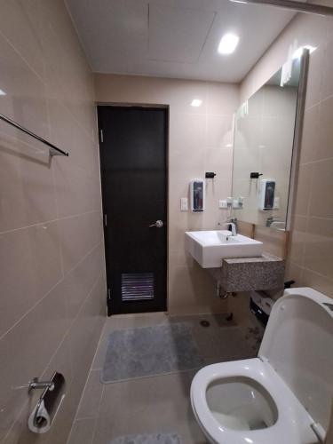 a bathroom with a toilet and a sink at Cozy maple grove studio with hot shower in General Trias