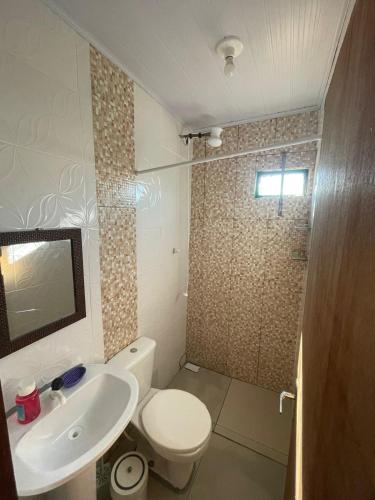 a bathroom with a toilet and a sink and a shower at Barra in Barra Velha