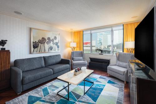 a living room with a couch and a tv at E Central Hotel Downtown Los Angeles in Los Angeles