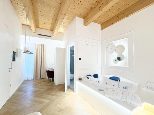 a bathroom with white walls and a wooden ceiling at La Divina - free parking - in Tropea