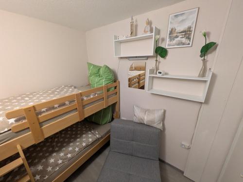a room with two bunk beds and a chair at Bocksbergbande in Goslar