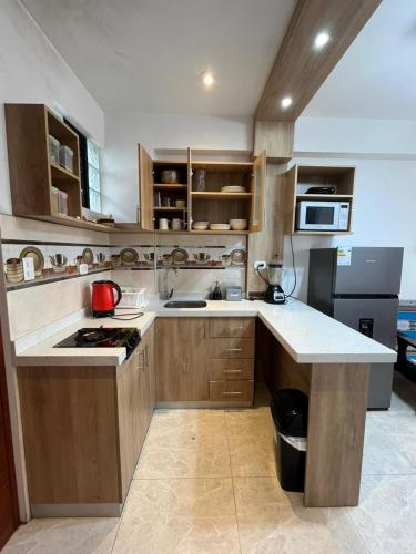 a kitchen with wooden cabinets and a counter top at Aparthotel Cusco in San Antonio